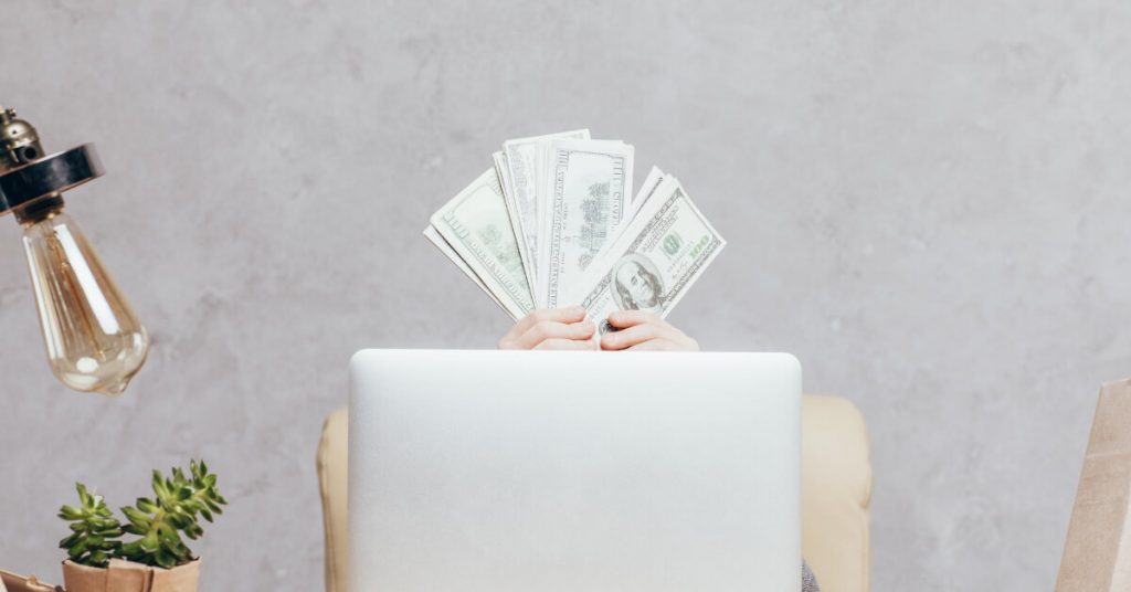 A man showing some dollars