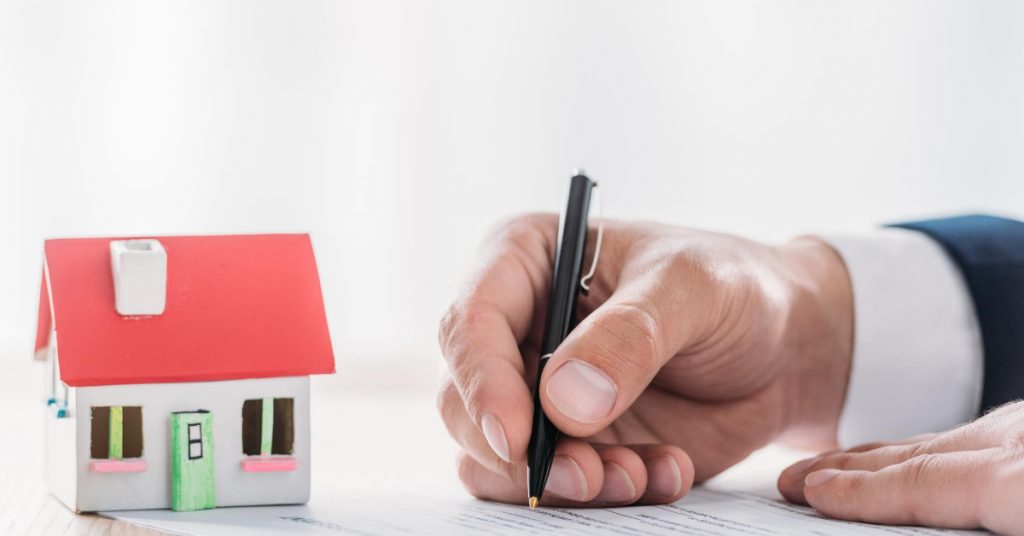 A man that is signing a financial document